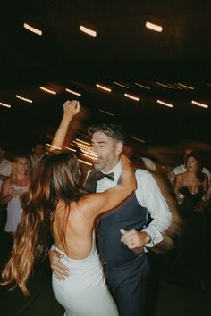 a man and woman dancing at a wedding