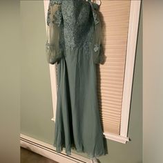 Beautiful Seafoam Green Long Dress Perfect For The Mother Of The Bride. This Dress Is Brand New With Tags And Is A Size 6. The Dress Is Made With High-Quality Materials To Ensure It Lasts For Many Formal Occasions To Come. Its Elegant And Classic Style Makes It Ideal For Formal Events Such As Weddings And Special Occasions. The Dress Is A Regular Size And Features A Stunning Green Color That Is Sure To Turn Heads. Get Ready To Make A Statement At Your Next Event With This Gorgeous Dress! There I Mother Of The Bride Dress With Sheer Long Sleeves, Fitted Green Dress For Mother Of The Bride, Green Fitted Dress With Sheer Sleeves, Green Floor-length Dress With Sheer Sleeves, Green Fitted Long Sleeve Mother Of The Bride Dress, Fitted Green Dress With Lace Sleeves, Green Long Dress, Long Green Dress, Seafoam Green