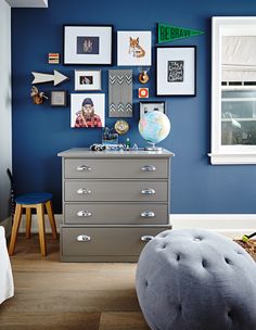 the front page of an interior design magazine with pictures on the wall and below it is a chest of drawers