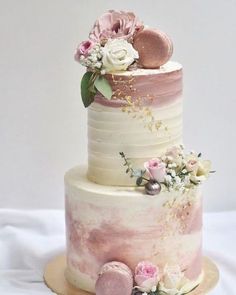 a three tiered cake with flowers on top