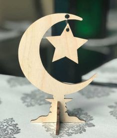 a wooden moon and star decoration on top of a table