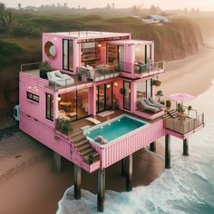 a pink house on the beach with a pool in it's center and deck