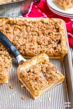 apple slab pie recipe on a baking sheet with an apple in the background and text overlay