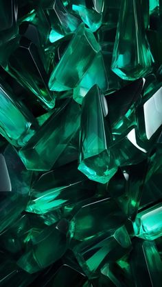 many green crystals are stacked together on top of each other