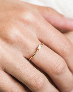 Our dainty baguette ring is the sweetest little addition to our stacking ring collection. It features a tiny little cubic zirconia baguette in the middle. Stack it with your favorite rings, or wear it alone! Made of 14k gold vermeil - perfect for daily wear without turning your finger green. Find more dainty necklaces, everyday earrings, and dainty stacking rings at Simple & Dainty. Elegant Simple Design Midi Wedding Ring, Chic 14k Gold Rings For Everyday, Chic Everyday 14k Gold Rings, Dainty Gold Baguette Jewelry, Elegant Everyday Jewelry With Baguette Diamonds, Elegant 14k Gold Midi Rings For Everyday, Elegant Everyday Midi Rings In 14k Gold, Elegant Everyday 14k Gold Midi Rings, Delicate Baguette Diamond Jewelry For Everyday