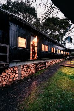 two people standing on the porch of a train car