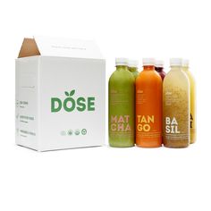 six bottles of juice are lined up in front of a box that says dose