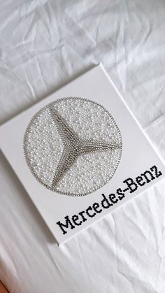 a card with the word mercedes written in black ink on it and a white background