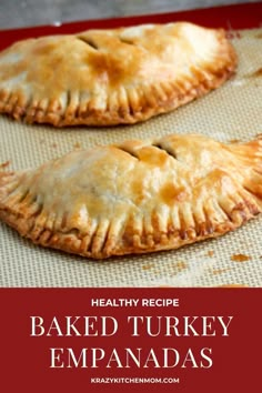 baked turkey empanadas on a baking sheet with text overlay reading healthy recipe baked turkey empanadas