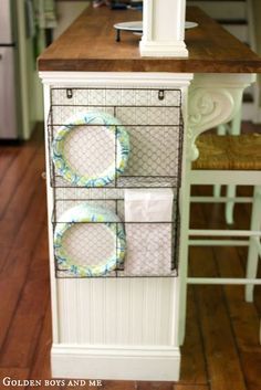 a cabinet with some plates and napkins in it