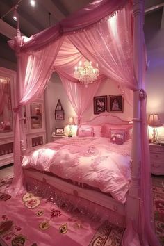 a bedroom with pink bedding, chandelier and pillows on the floor in front of it