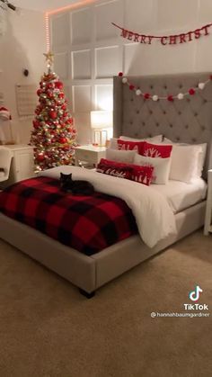 a bedroom decorated for christmas with red and white decor