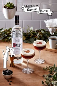 a bottle of alcohol sitting on top of a wooden table next to two wine glasses