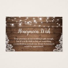 a wooden business card with lights and the words honeymoon wish on it, in white lettering