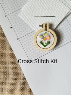 a cross stitch kit with a flower on it