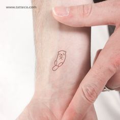 a person with a small tattoo on their wrist