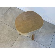 a wooden table sitting on top of a tile floor