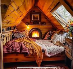 an attic bedroom with a bed, fireplace and rugs on the floor in front of it