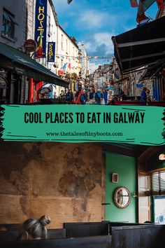 a dog sitting on the ground in front of a building with a sign that says cool places to eat in galaxy