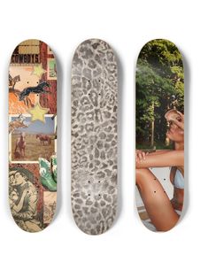 three skateboards with different pictures on them, one is white and the other is brown