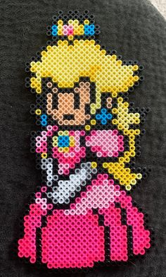 a close up of a piece of art made out of perler beads with the character sailor moon on it