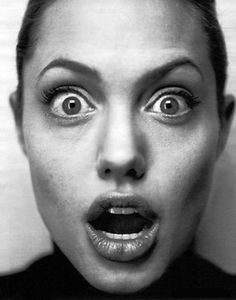 a woman with her mouth open and eyes wide open, making a creepy face for the camera