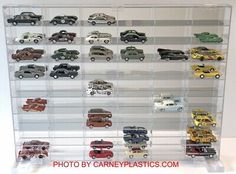 a display case filled with lots of different types of toy cars on it's sides