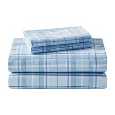 the blue plaid sheets are folded on top of each other