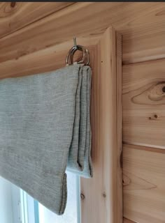 a curtain hanging on the side of a wooden wall