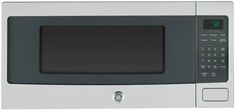 a silver microwave oven with an electronic clock on the front and side panel showing time