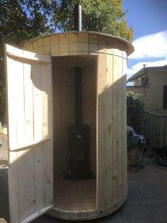 a small wooden outhouse sitting on top of a patio