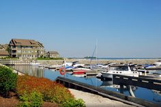 several boats are docked in the water next to houses