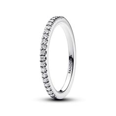 From Pandora, choose delicate sparkle when you wear the Sparkling Band Ring. An essential piece for every collection, this sterling silver ring is set with a row of clear cubic zirconia. The pave row sparkles from the outer front half of the band, which features a squared profile. Peek inside the band to see the engraved iconic Pandora logo. Whether you wear it solo for subtle sparkle or stack it with other styles, this cubic zirconia ring will elevate your everyday. Pandora Style #: 192999C01-5 Classic Sterling Silver Diamond Ring With Sparkling Stones, Classic Rings With Sparkling Stones For Formal Events, Classic Rings With Sparkling Stones For Formal Occasions, Classic Promise Ring With Sparkling Stones, Classic Sterling Silver Rings With Sparkling Stones, Classic Rings With Sparkling Round Cut Stones, Classic Sparkling Rings For Promise, Classic Cubic Zirconia Rings With Sparkling Stones, Classic Sparkling Sterling Silver Diamond Ring