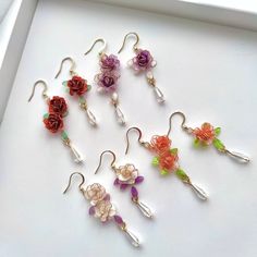 Handmade Colorful Rose Flower Earrings These unique handmade earrings feature a beautifulrose design. Crafted from high quality materials, they make a perfect gift for the special someone in your life. Show your loved one how much you care with these stunning rose earrings. Detail: - Size of earring: 50mm Material: flowers - resin; ear wires - sterling silver The Handmade Rose Flower Earrings are sold in pairs of two earrings. Wire Wrapped Flower Earrings As Gift, Whimsical Flower Charm Earrings For Gift, Handmade Flower Earrings As Gift For Her, Rose Red Flower Earrings, Whimsical Flower Earrings With Flower Charm As A Gift, Handmade Flower Drop Earrings As Gift, Gift Wire Wrapped Flower Drop Earrings, Gift Handmade Flower Earrings, Rose Red Flower Earrings For Pierced Ears