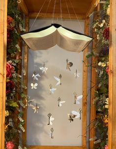 a wooden frame with flowers and keys hanging from it