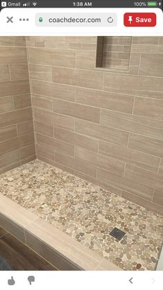 a walk in shower sitting inside of a bathroom next to a tiled floor and wall