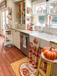 a kitchen with wooden floors and white cabinets