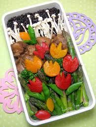 a white tray filled with vegetables and mushrooms