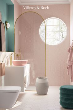 a bathroom with pink and green walls, white flooring and a round mirror on the wall