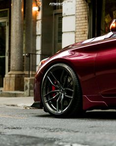 a red sports car parked in front of a building