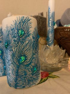 blue and white candles are sitting on a table