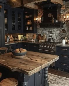 a rustic kitchen with dark blue cabinets and wooden table in the center, surrounded by stools