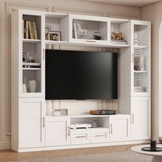 an entertainment center with white cabinets and a large flat screen tv mounted on the wall