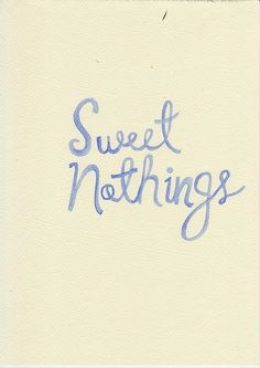 the words sweet nothing are written in blue ink on a white paper with a black border