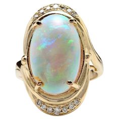 5.35 Carats Natural Impressive Ethiopian Opal and Diamond 14K Solid Yellow Gold Ring The opal has beautiful fire, pictures don't show the whole beauty of the opal! Total Natural Opal Weight is: 5.00 Carats Opal Measures: 17.88x 11.20mm Total Natural Round Diamonds Weight: .35 Carats (color G / Clarity VS2-SI1) Ring size: 7 (we offer free re-sizing upon request) Ring total weight: 9.3 grams Disclaimer: all weights, measurements and colors are approximate and may vary slightly from the listed dime Opal Diamond Engagement Ring, Fire Pictures, Yellow Gold Cocktail Ring, Fire Opal Ring, Gold Statement Ring, Gold Cocktail Ring, Diamond Free, Yellow Gold Engagement Rings, Pretty Rings