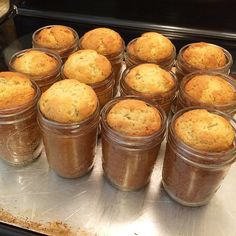 several jars filled with muffins sitting on top of a counter