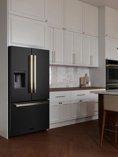 a black refrigerator freezer sitting inside of a kitchen