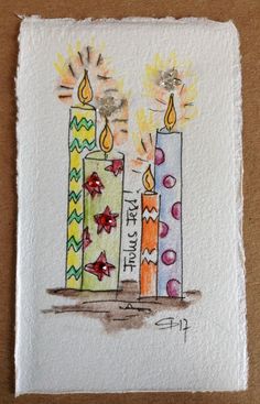 a drawing of three lit candles on a piece of paper