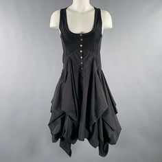 Allsaints Dress In A Black Polyester Blend Fabric Featuring A Tank Style With Pleated Bodice Details, Asymmetrical Skirt, And Front Button Closure. Excellent Pre-Owned Condition. Marked: Eu 36 Measurements: Shoulder: 11 Inches Bust: 30 Inches Waist: 28 Inches Hip: 40 Inches Length: 40 Inches Sui Generis Reference: 131846 Category: Dress More Details Brand: Allsaints Gender: Female Size: 4 Color: Black Fabric: Polyester Blend Material: Polyester Style: Asymmetrical Age Group: Adult Sui Generis De Fitted Sleeveless Lagenlook Dress, Spring Gothic Asymmetrical Dresses, Black Fitted Midi Dress With Handkerchief Hem, Fitted Black Midi Dress With Handkerchief Hem, Black Fitted Dress With Handkerchief Hem, Lagenlook Fitted Dress With Asymmetrical Hem, Black Fitted Asymmetrical Dress With Handkerchief Hem, Spring Midi Dress By Allsaints, Summer Fitted Midi Dress By Allsaints