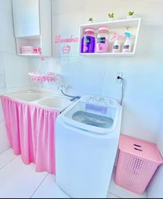 a pink and white bathroom with a washer and dryer